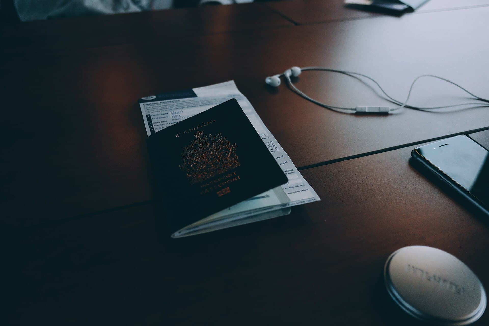 A passport and boarding pass on a desk