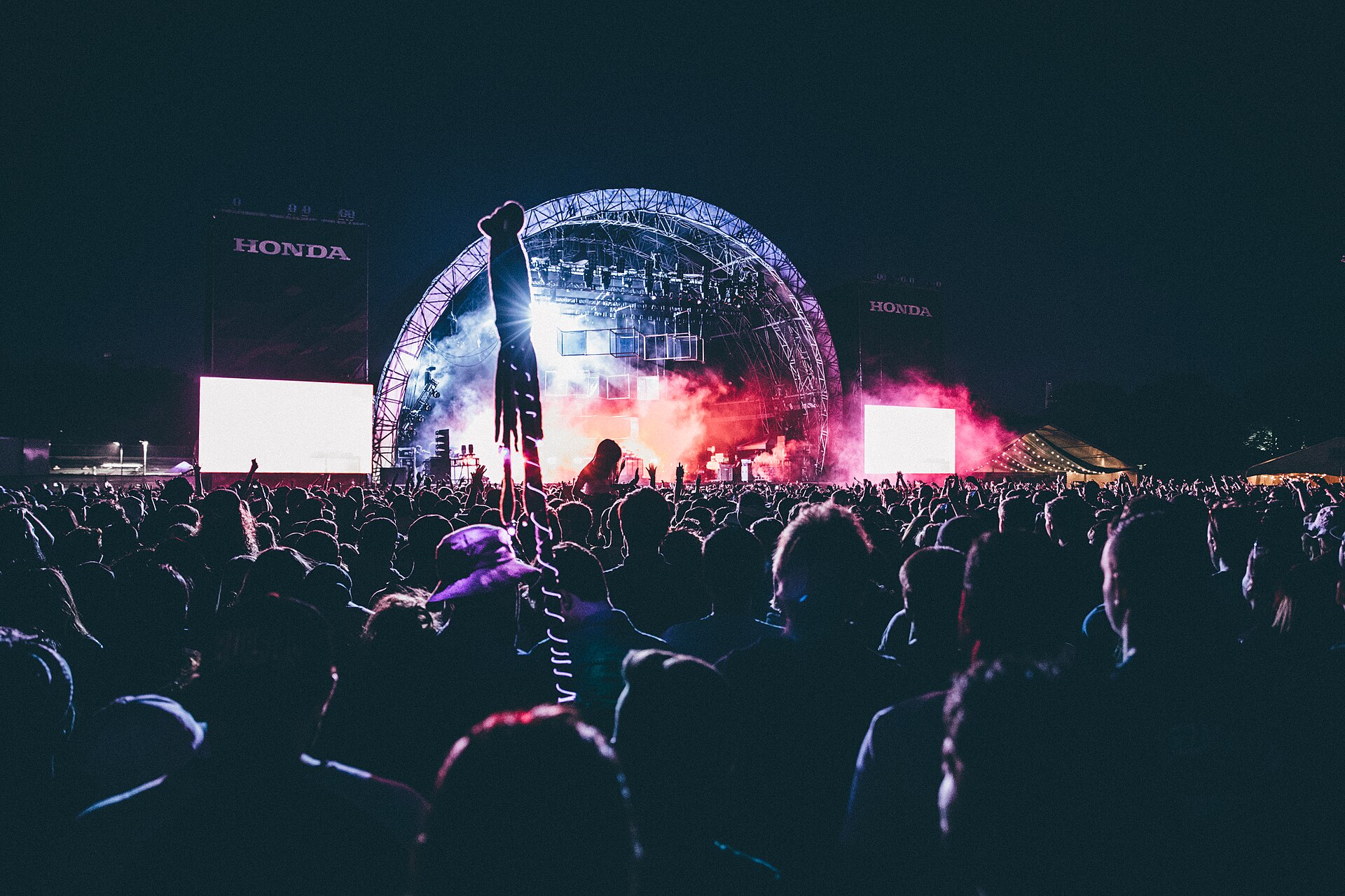 A festival stage at night with a crowd